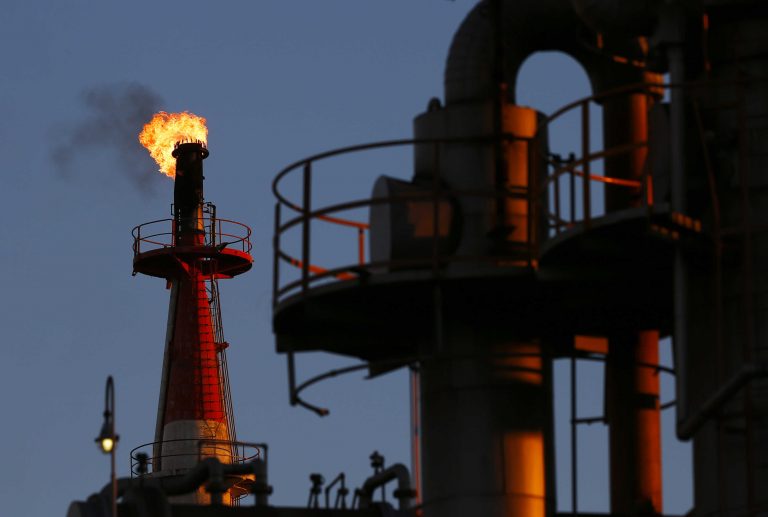 A flame shoots out of a chimney at a petro-industrial factory in Kawasaki near Tokyo